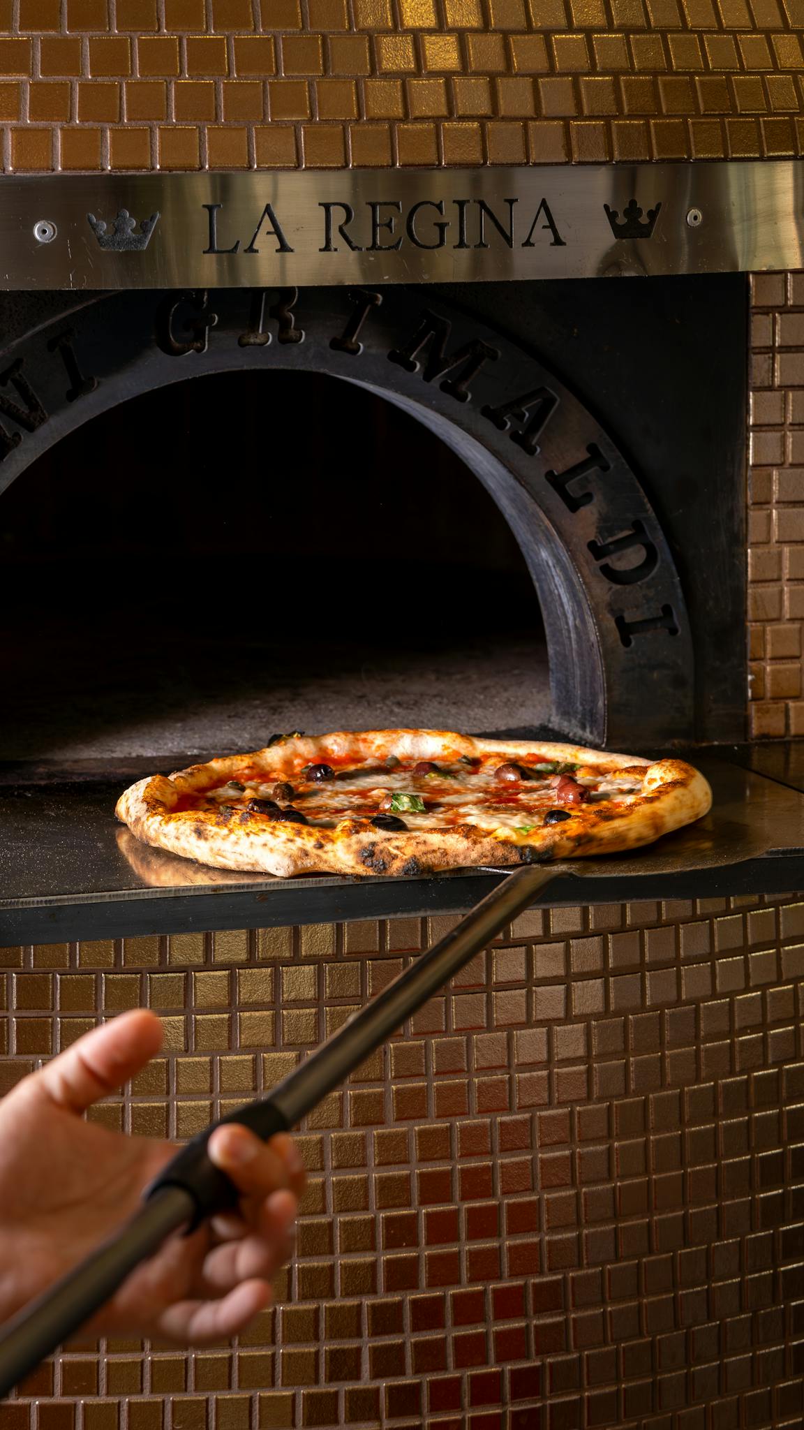 Close-up of a delicious pizza being baked in a traditional wood-fired oven.
